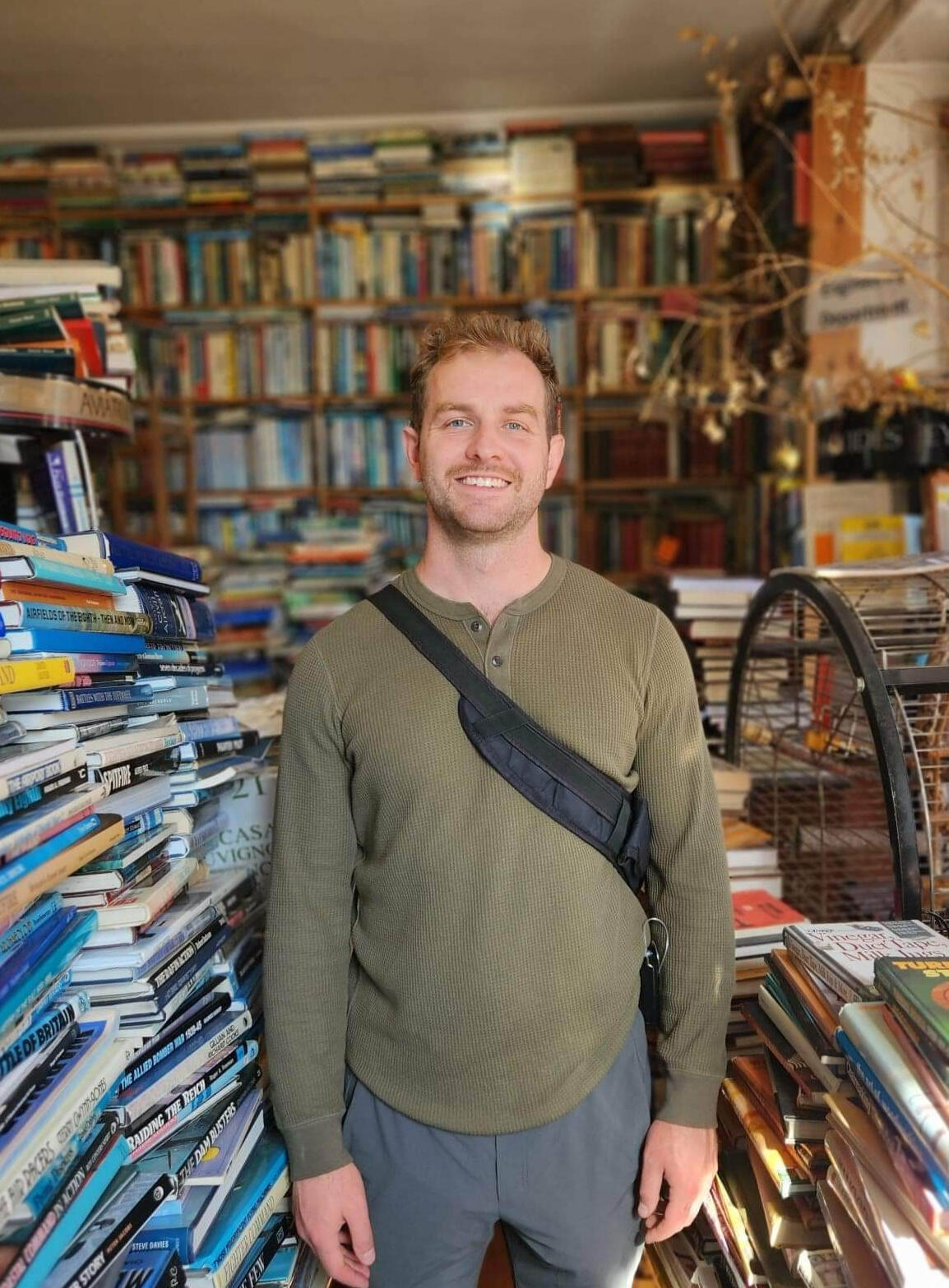 Paul Stanfield in a cluttered used book store.